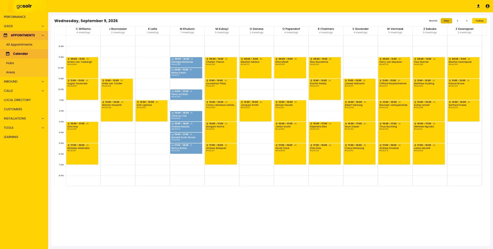 A day-view calendar with twelve consultant columns, each holding two-hour appointment blocks with a reference.