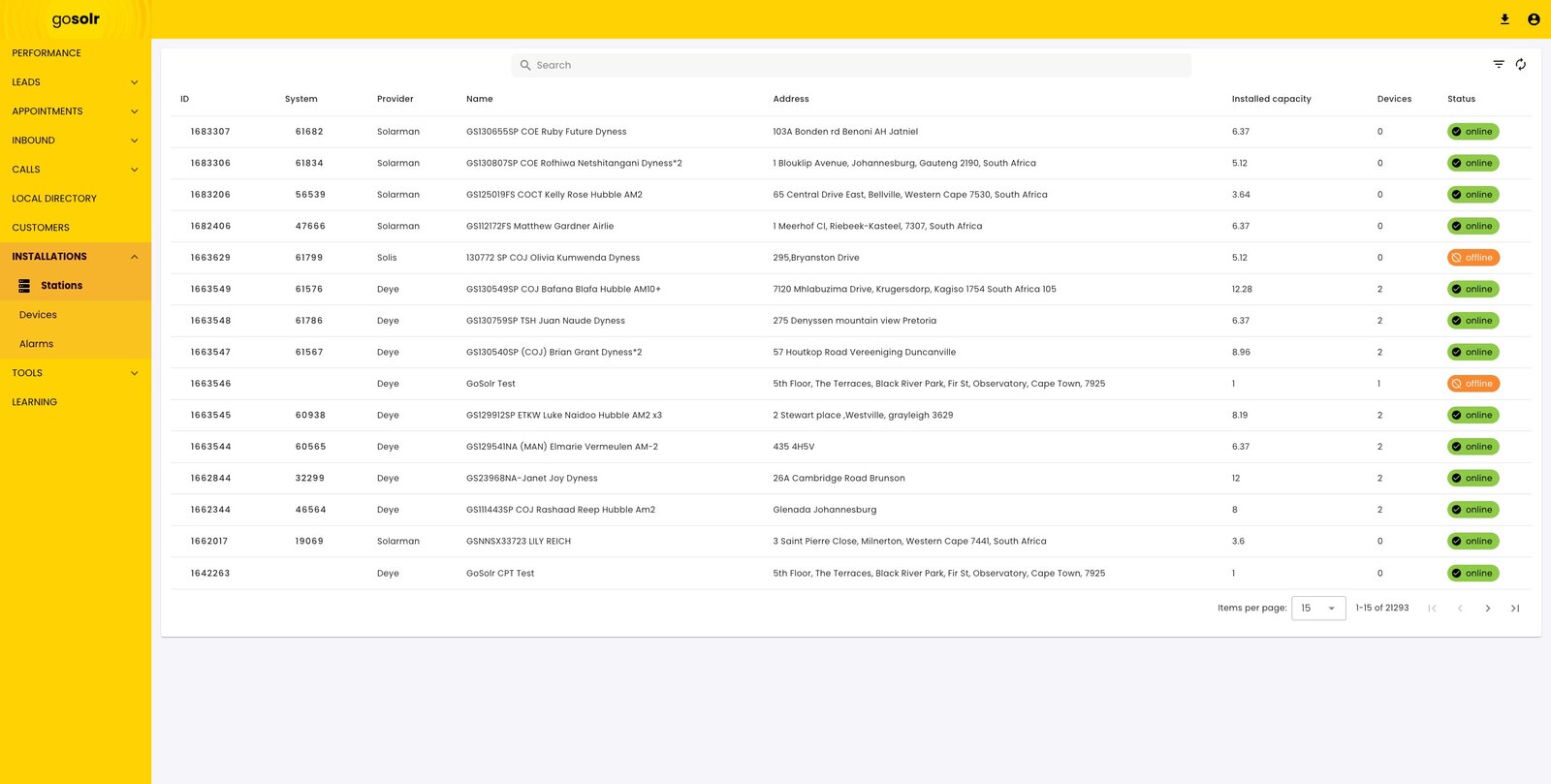 The stations list: rows of installations with provider, name, address, installed capacity, device count and an online or offline status pill.